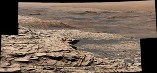 NASA's Curiosity Mars rover captured this view, which was stitched together from 28 different images, from "Greenheugh Pediment" on April 9, 2020. In the foreground is the pediment's sandstone cap. At center is the "clay-bearing unit," and the floor of Gale Crater is in the distance.