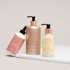 3 Grow Gorgeous hair mask products on a pale pink background and marble tray