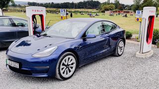 Tesla Model 3 parked in charging station