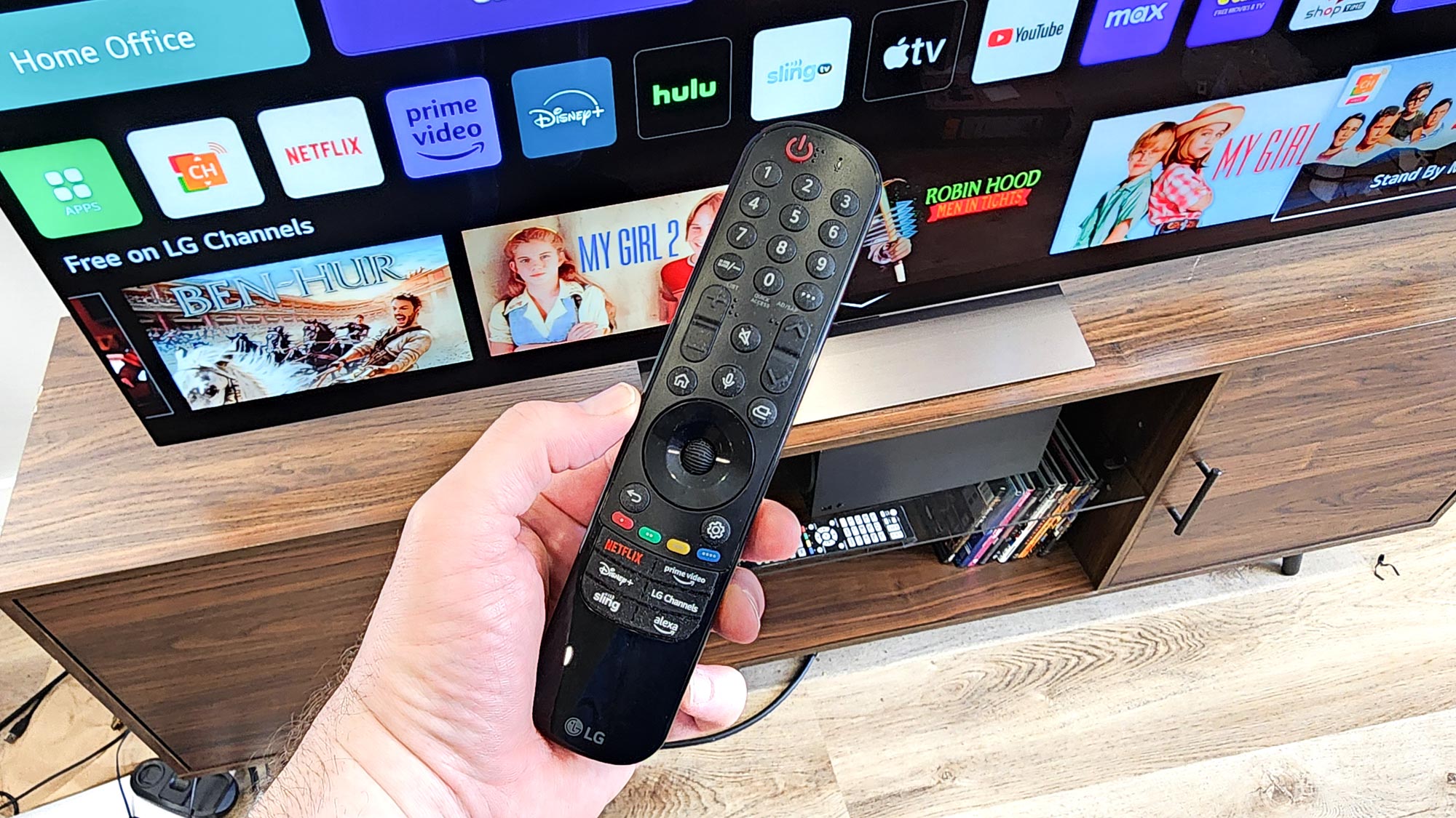LG C4 OLED TV remote shown in a living room