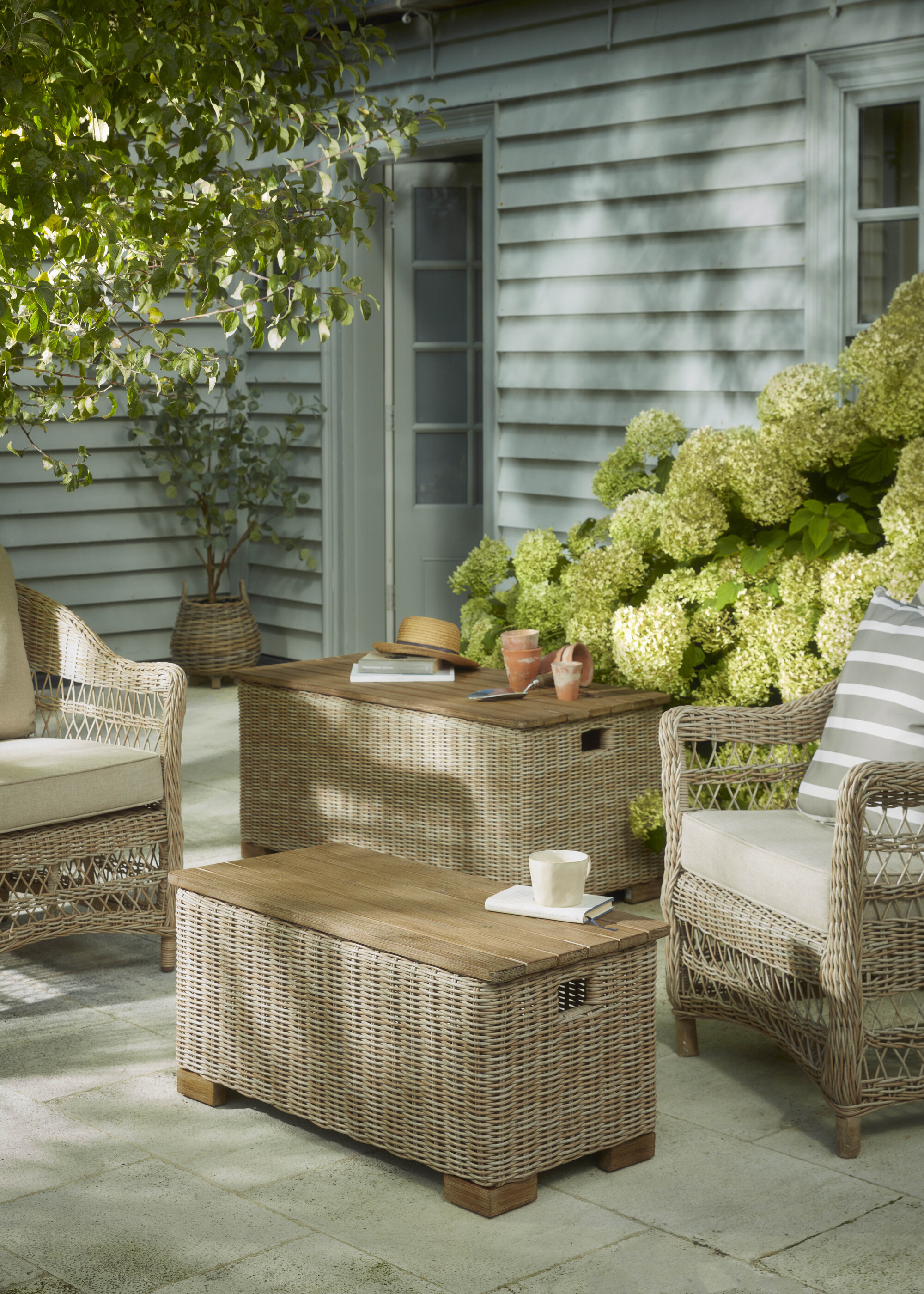 Wicker garden furniture on a patio with hidden storage ottomans