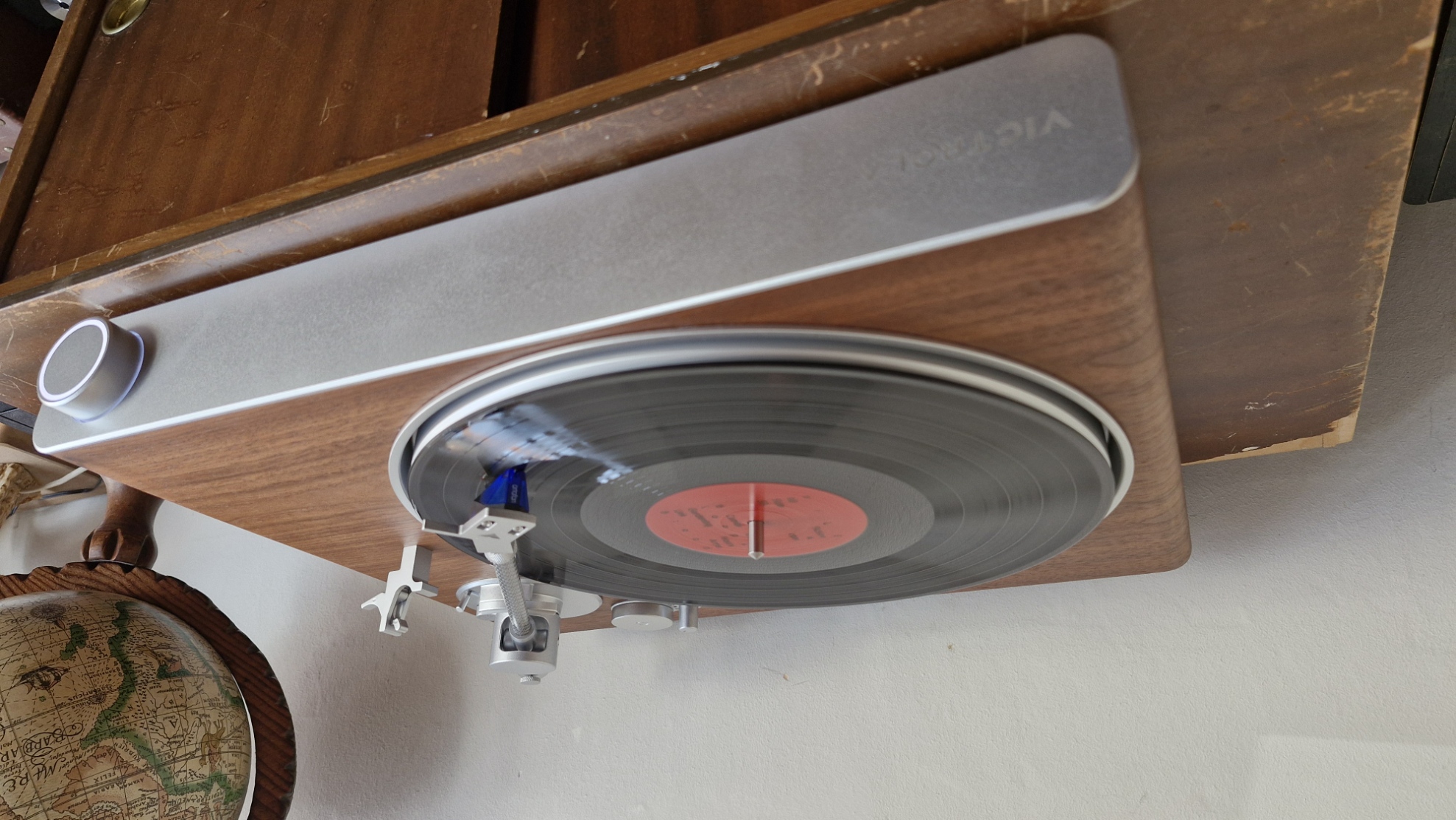 Victrola Stream Sapphire turntable, with light-up knob, on a wooden table