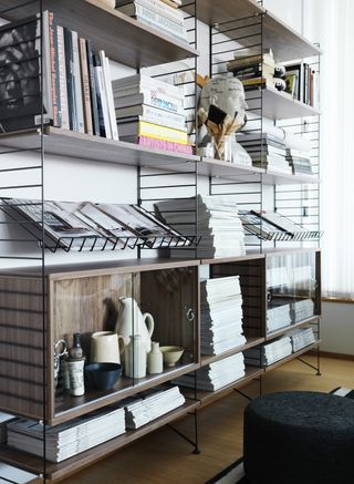 Modern bookshelf decorated with coffee table books and vases