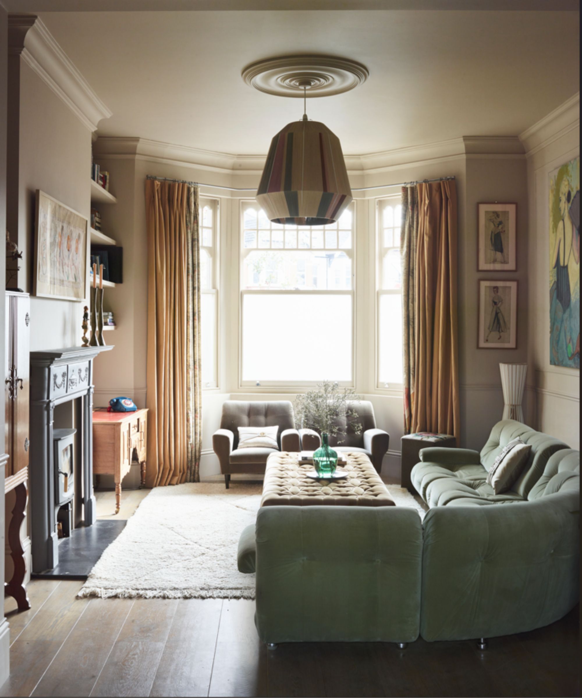 Cozy living room with curved sofa and statement pendant lighting