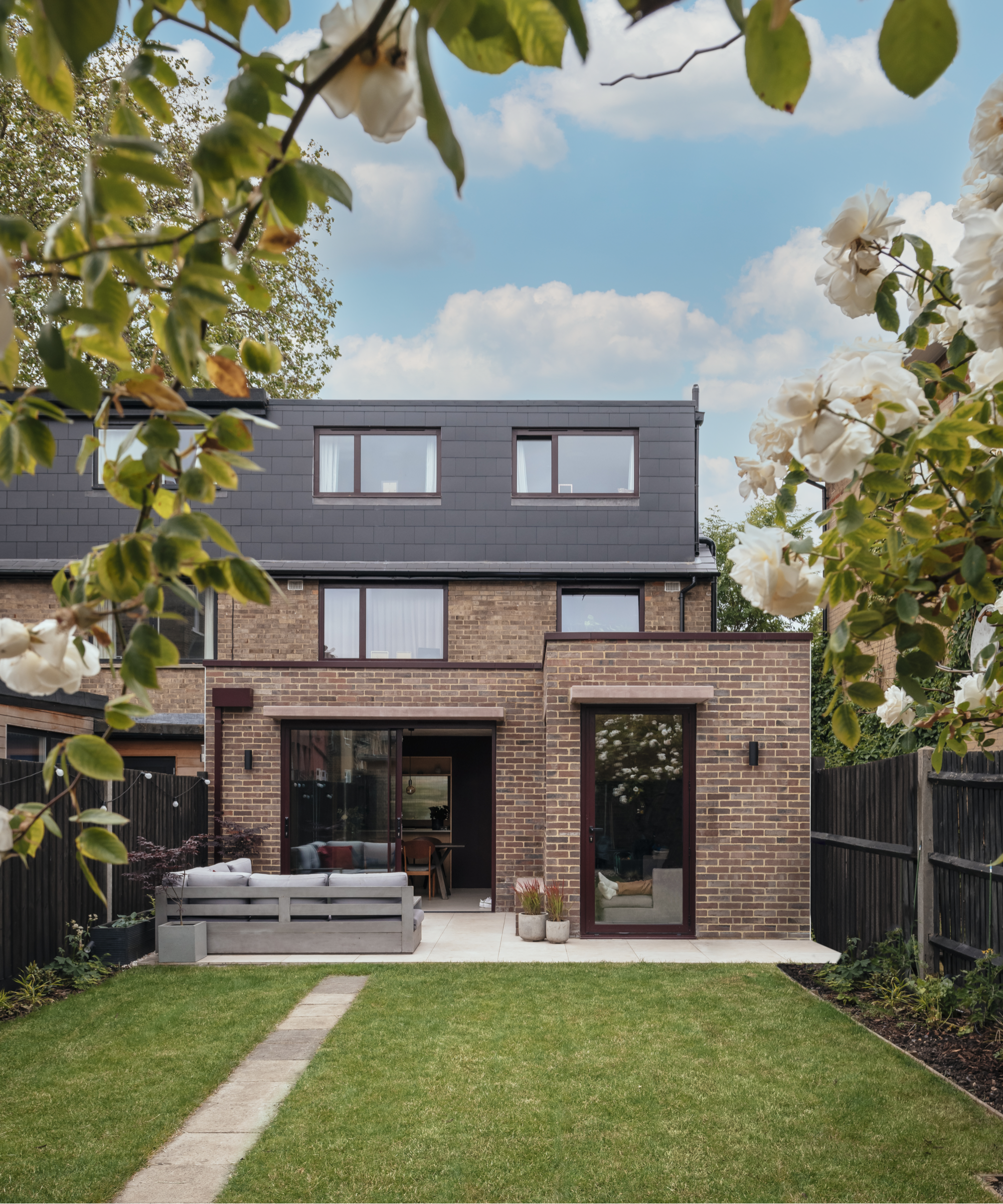 Exterior of the back of the house and garden patio and lawn