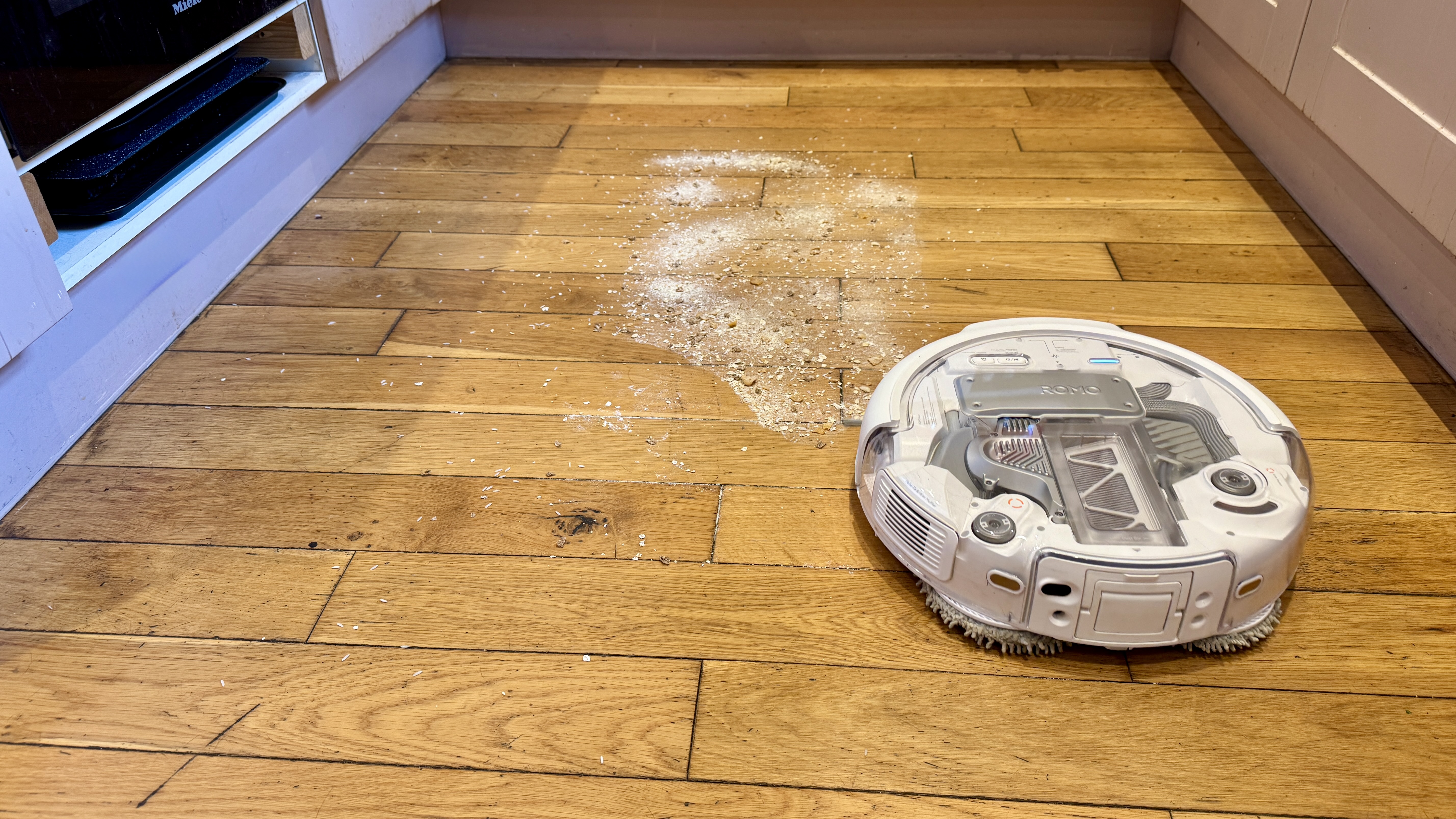 DJI Romo P robot vacuum about to clean flour from hard floor