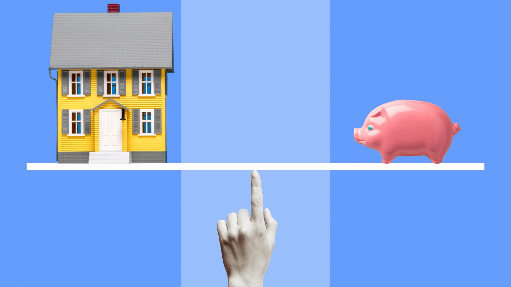 Yellow miniature model house and pink ceramic piggy bank on white line balanced on black and white woman's finger, blue background