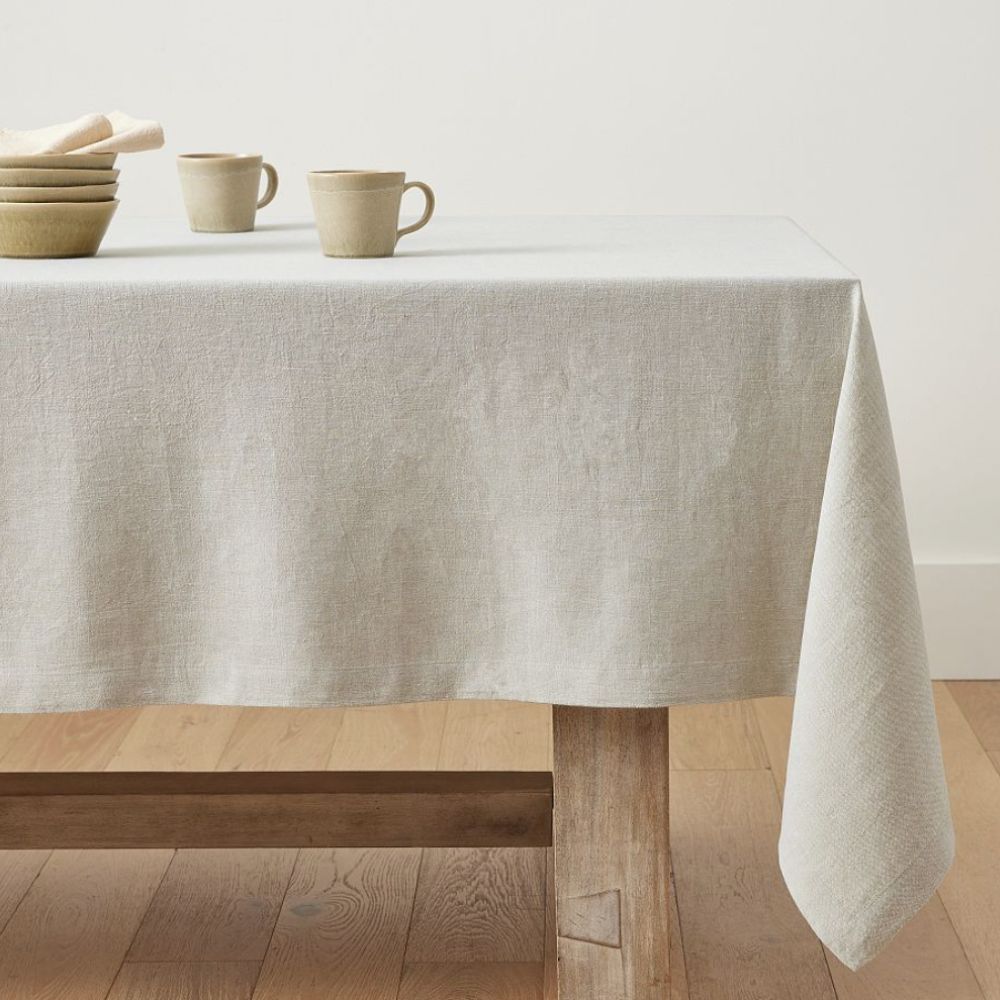Cream linen tablecloth on a wooden table