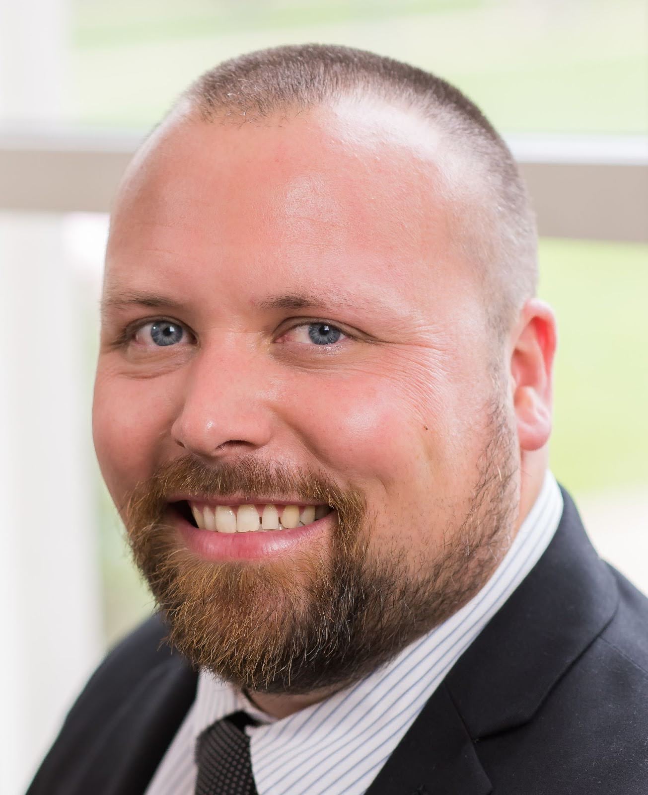 Head and shoulders of a smiling man