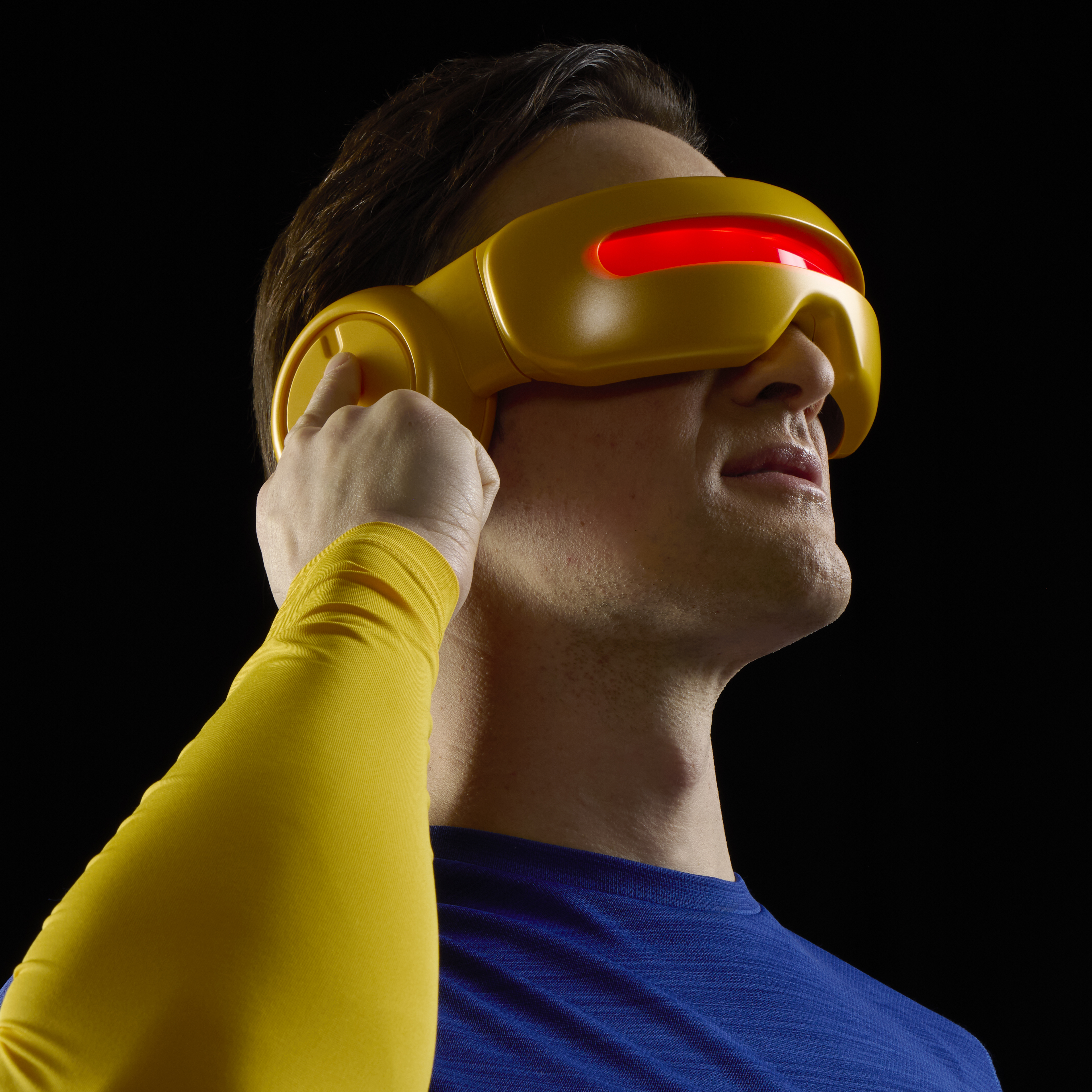 A man holds the X-Men Cyclops Visor against a dark background