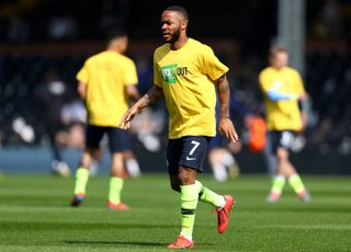 Raheem Sterling of Manchester City warms up while wearing a Kick It Out racism shirt prior to the Premier League match between Fulham FC and Manchester City at Craven Cottage on March 30, 2019 in London, United Kingdom.