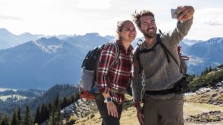 Couple taking selfie on mountain