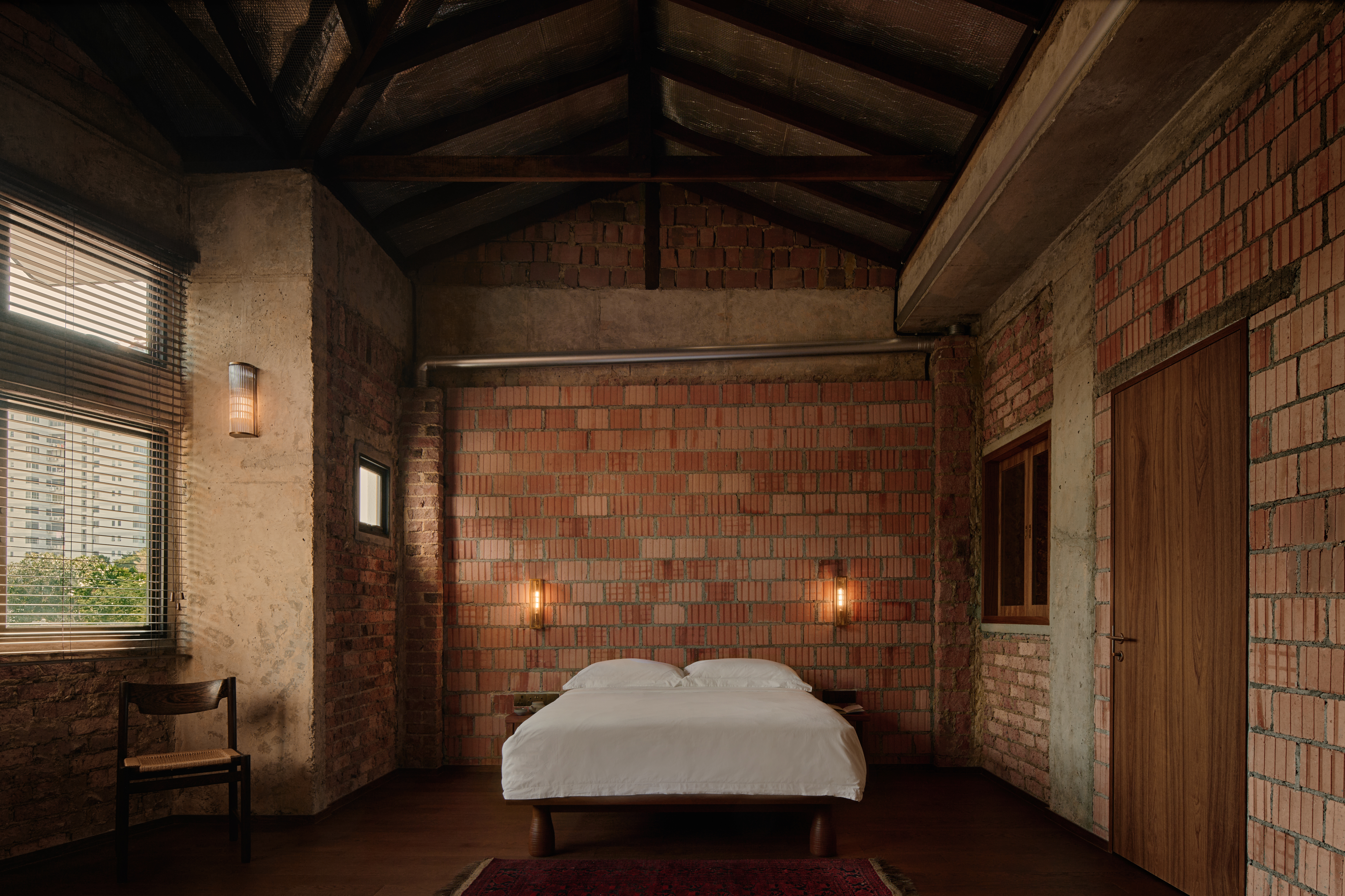 'My last home' by L Architects, a raw interior space of exposed brown brick and wood detailing