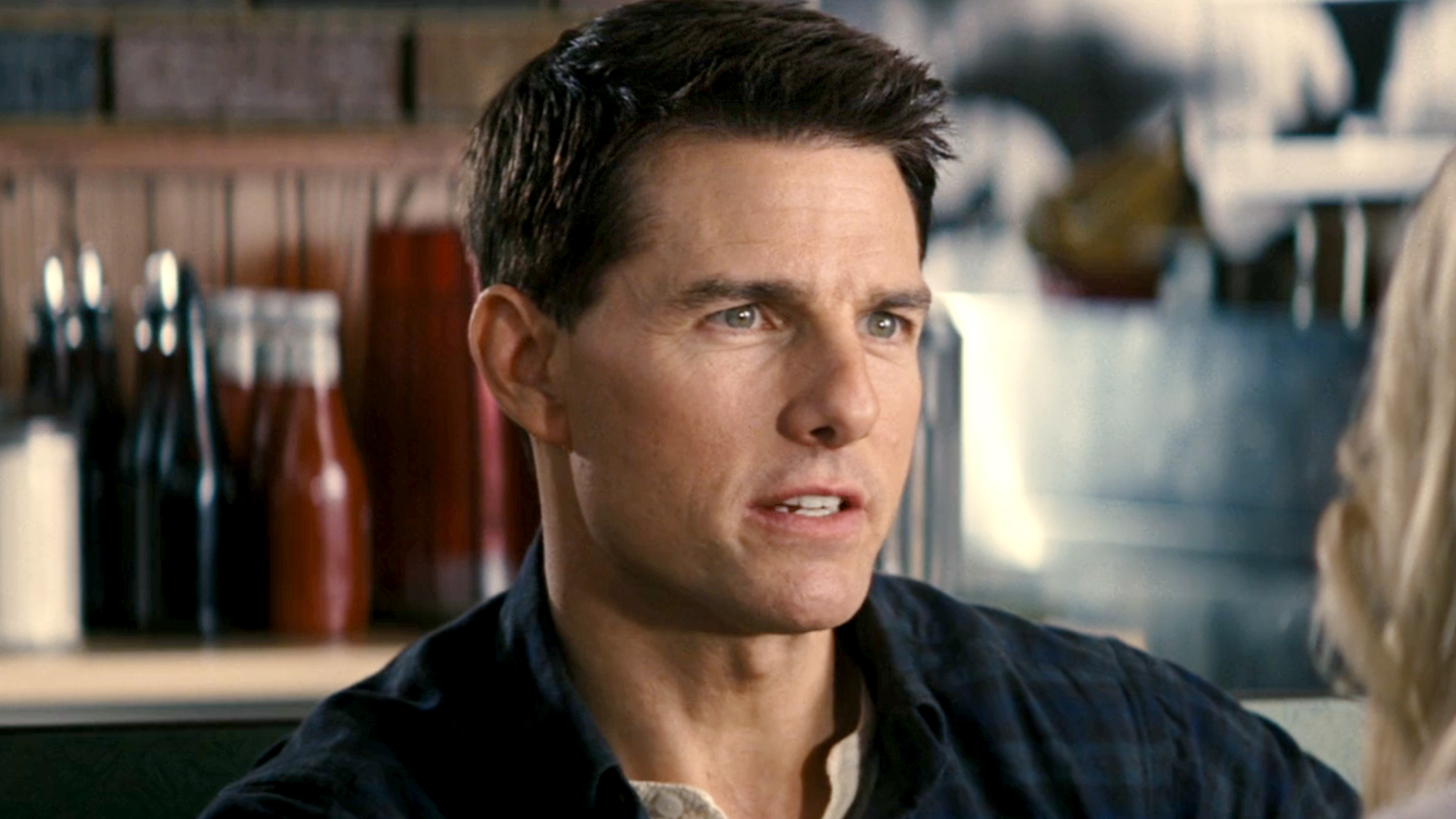 Tom Cruise, in a denim jacket as Jack Reacher in the movie of the same name (2012).