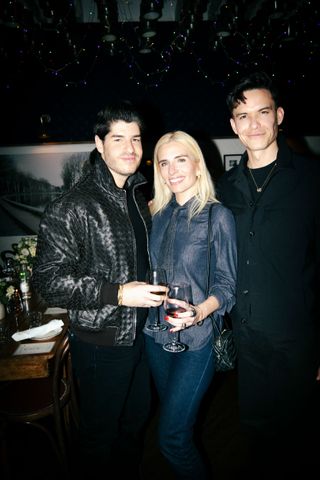 a group of three people at a dinner party