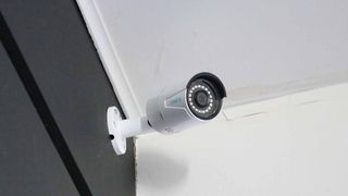 A Reolink PoE camera mounted in a corner inside a house