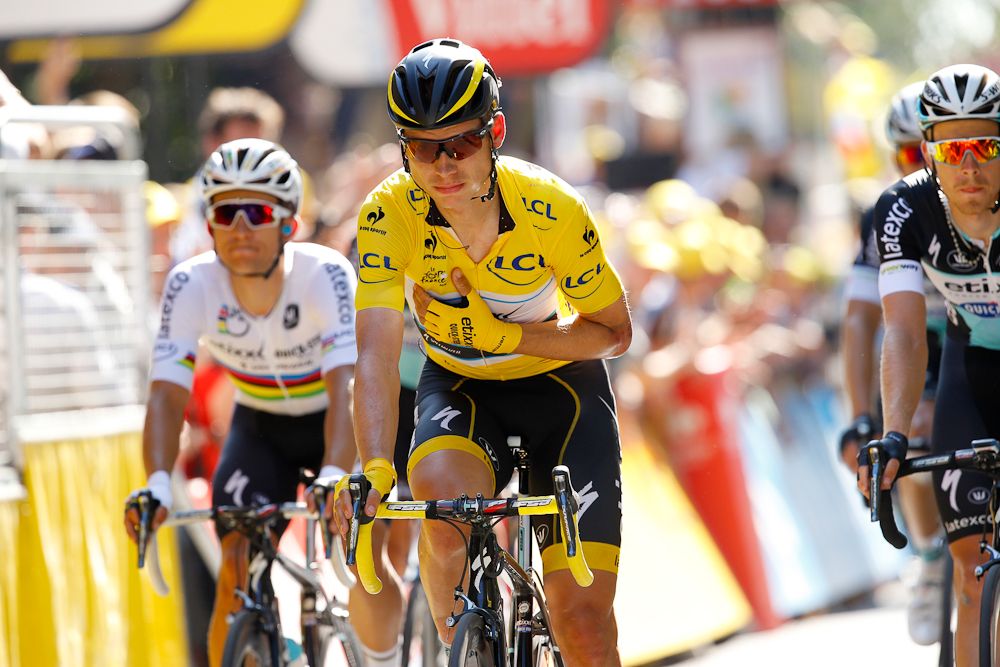 A battered Tony Martin crosses the finish line.