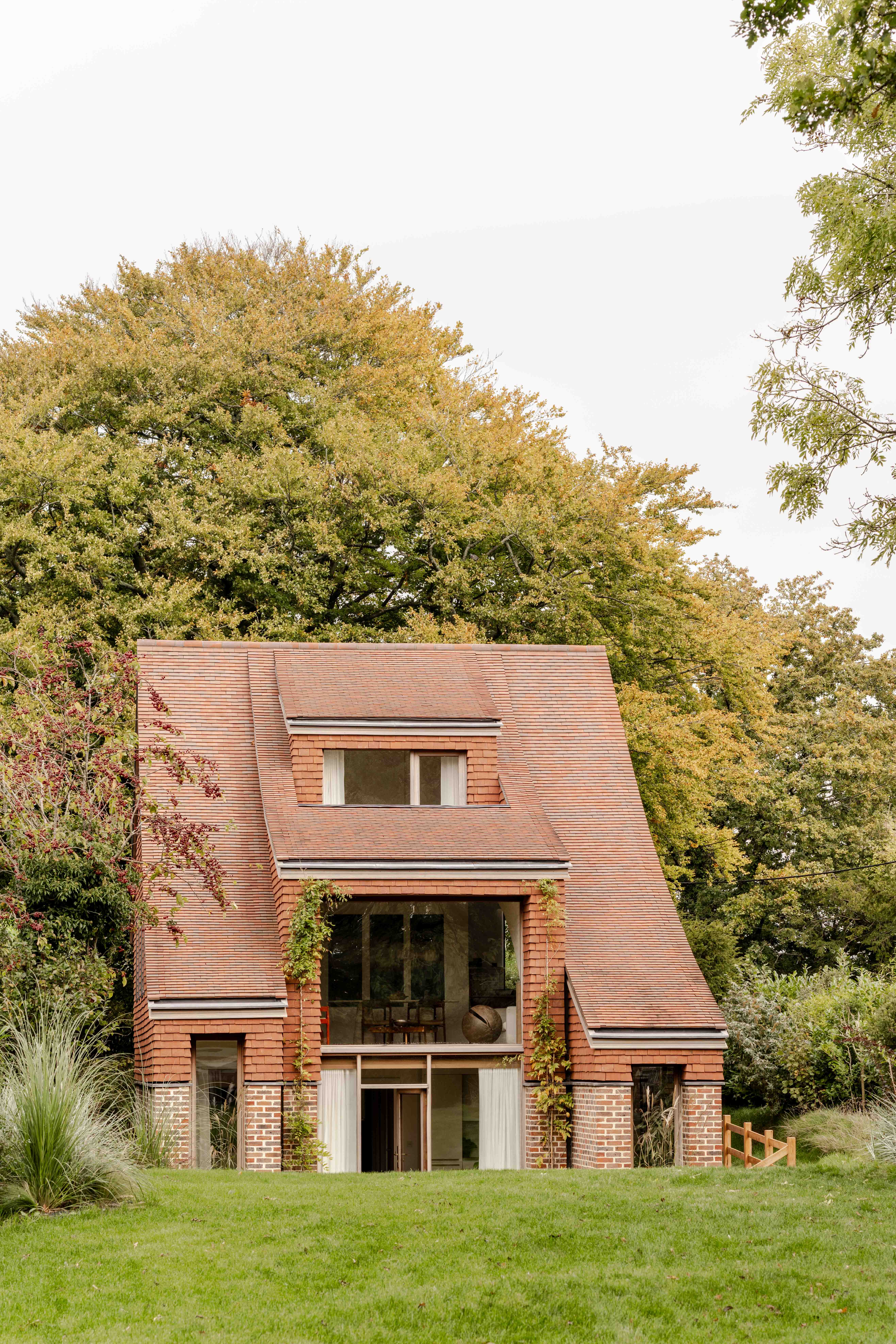 image of Clay Rise by Templeton Ford, a brick house with a curved roof in west sussex countryside