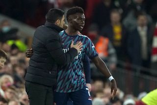 Arsenal manager Mikel Arteta with Bukayo Saka on the touchline during the Carabao Cup semi-final, first leg match at Anfield. Picture date: Thursday January 13, 2022