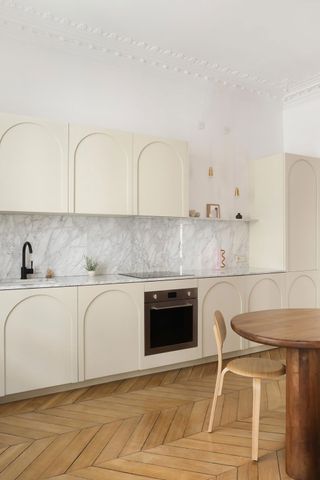 a beige kitchen with an arched door detail