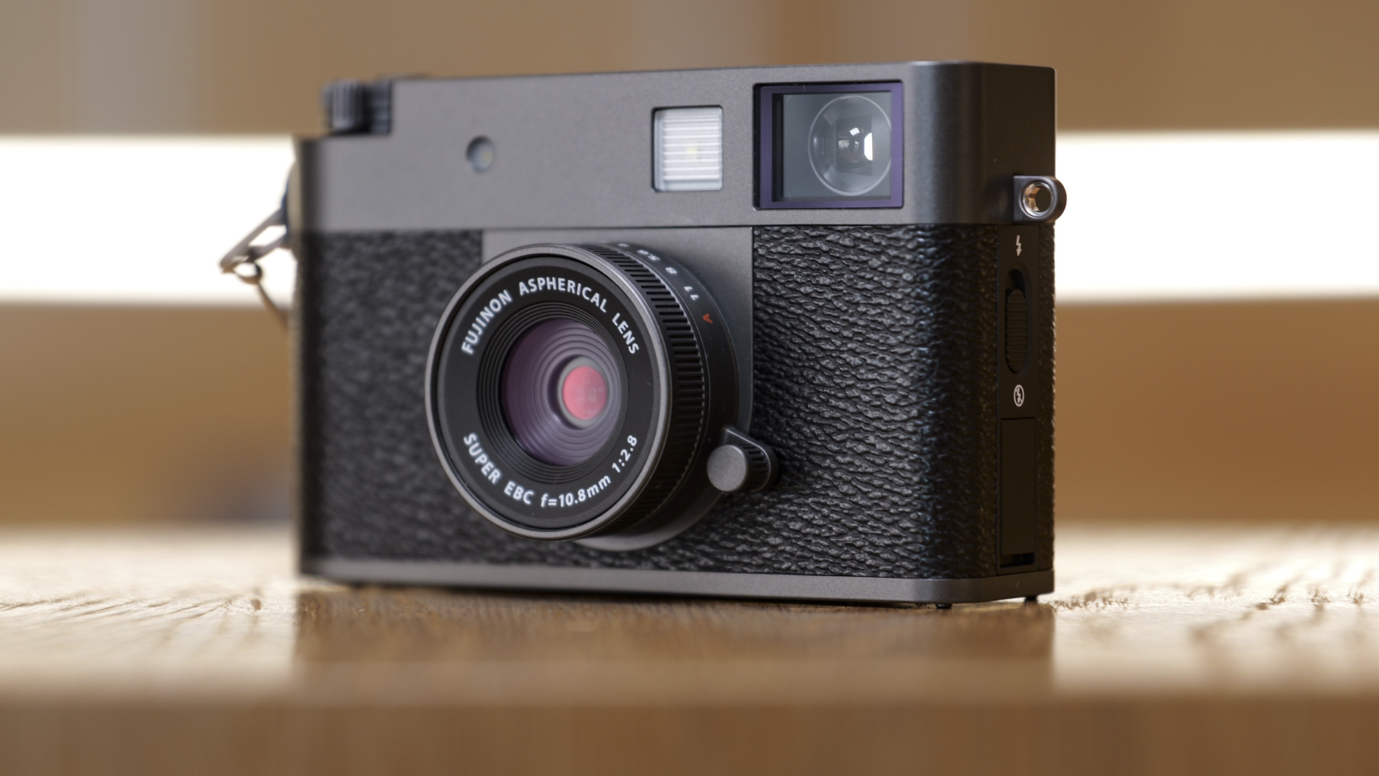 Fujifilm X half compact camera on a wooden surface