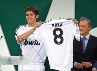Kaka holds up a Real Madrid shirt at his official presentation in June 2009 as president Florentino Perez watches on.