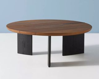 A solid wood coffee table with wide wooden legs