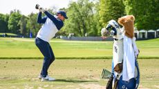 Rory McIlroy hits a drive during a practice session on the driving range