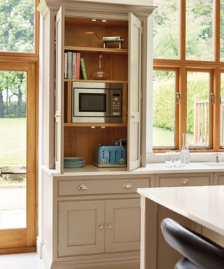 Kitchen appliance garage with taupe kitchen cabinets