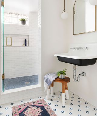 Bathroom with black sink, pug rug and patterned flooring