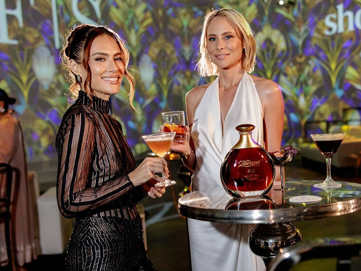 two women pose for photos at the Latin American Fashion Summit