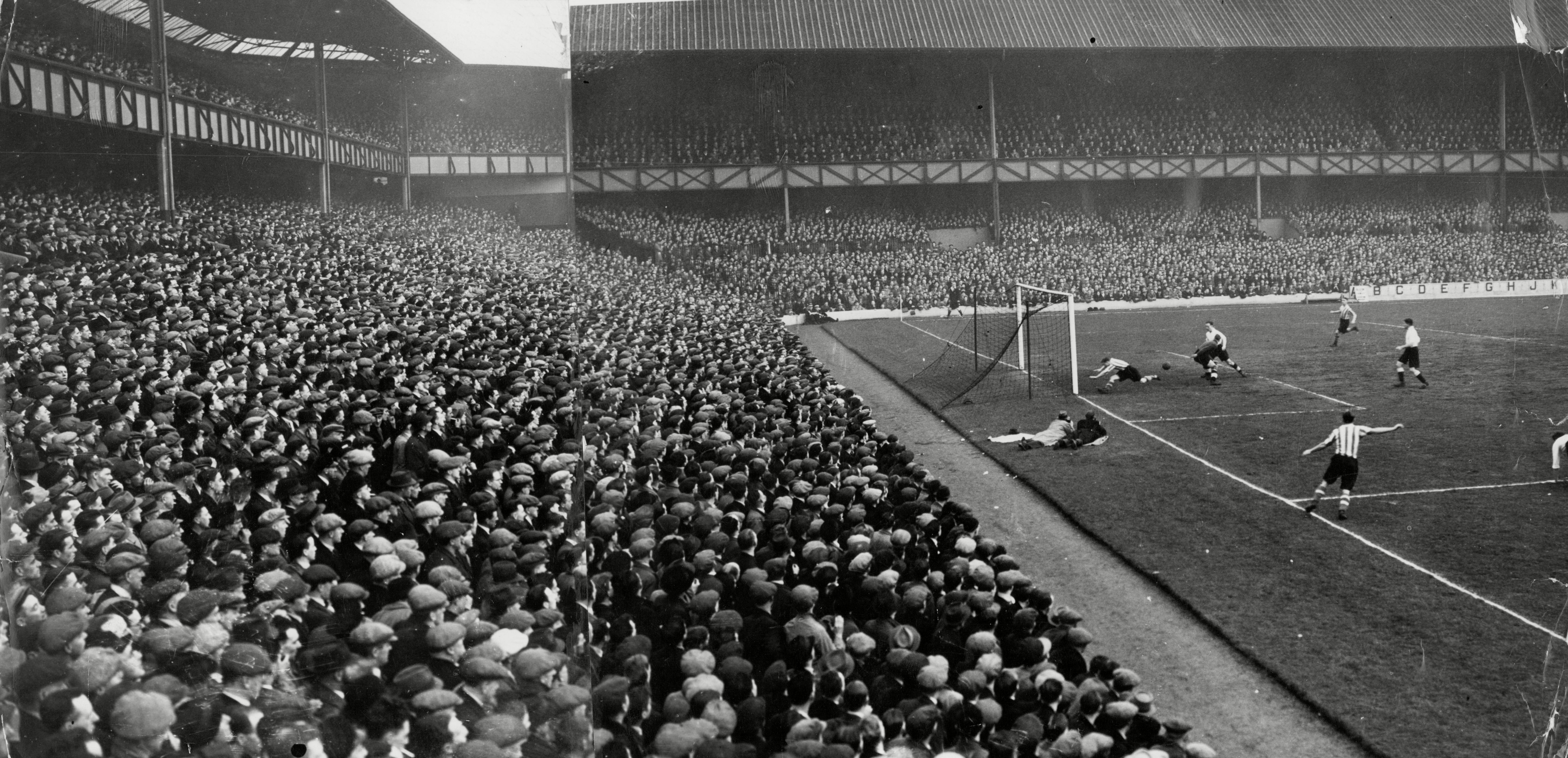 A black and white image of a football match taking place at Goodison Park in the 20th Century
