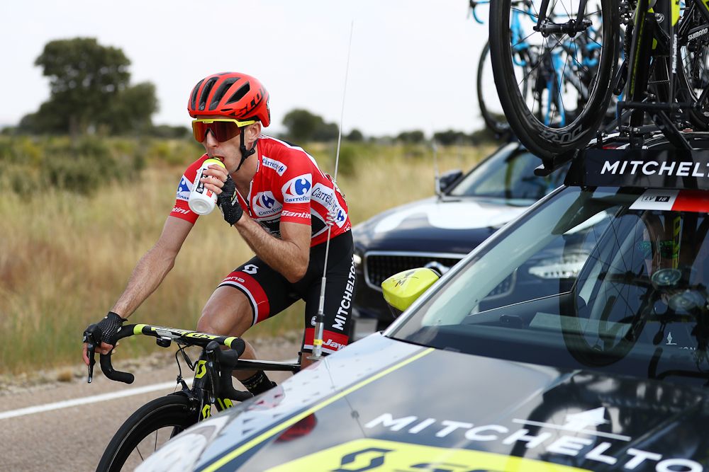 Overall leader Simon Yates visits the team car during stage 10 at the Vuelta