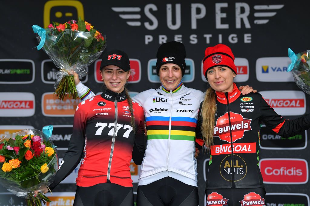 BOOM BELGIUM DECEMBER 04 LR Inge Van Der Heijden of The Netherlands and Team 777 on second place race winner Lucinda Brand of The Netherlands and Team Baloise Trek Lions and Denise Betsema of The Netherlands and Team Pauwels Sauzen Bingoal on third place pose on the podium ceremony after the 7th Superprestige Cyclocross Boom 2021 Womens Elite SPBoom Superprestige2022 on December 04 2021 in Boom Belgium Photo by Luc ClaessenGetty Images