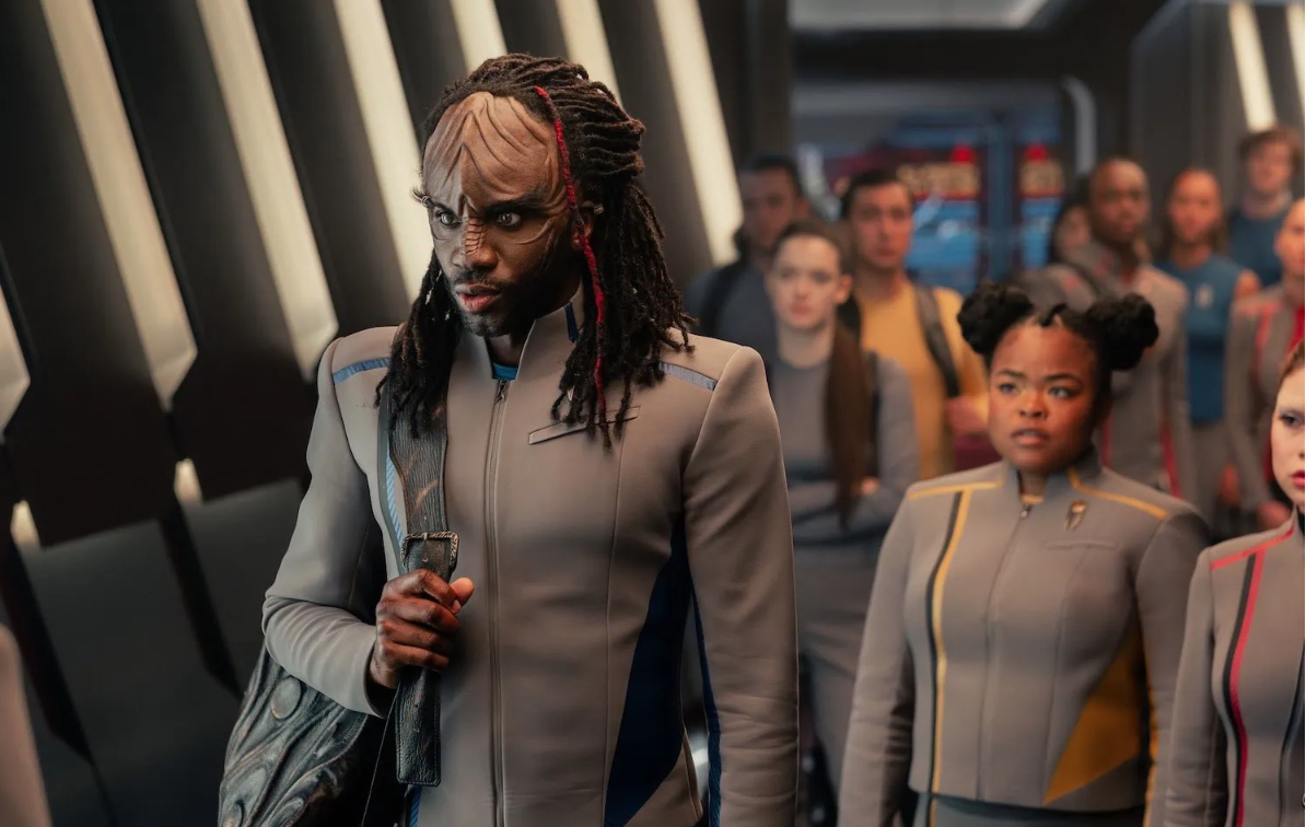 a tall male alien aboard a sci-fi spaceship