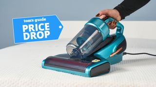 Blue Jimmy BX7 Pro mattress vacuum on white mattress