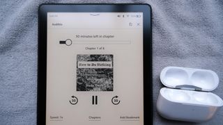Amazon Kindle Paperwhite Signature Edition with airpods pro case in Bluetooth mode