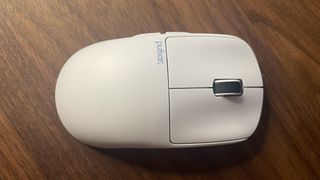 A Pulsar X2 CrazyLight Medium gaming mouse on a desk.
