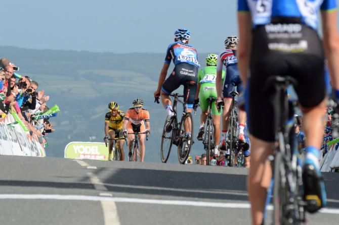 Riders head down to team buses off the Haytor mountain finish as others are still making their way to the line.