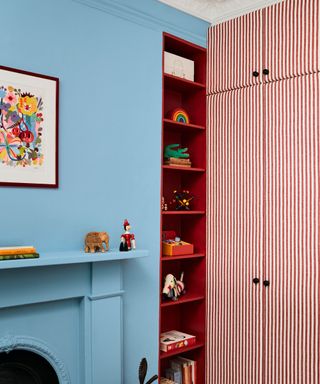 blue playroom bedroom with red wardrobes and shelving