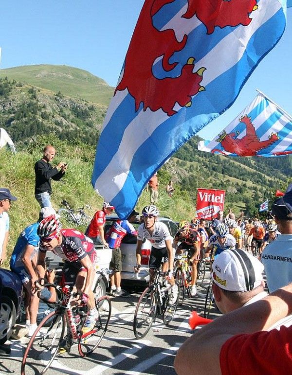 Evans leads Andy Schleck under the flags of Luxembourg.
