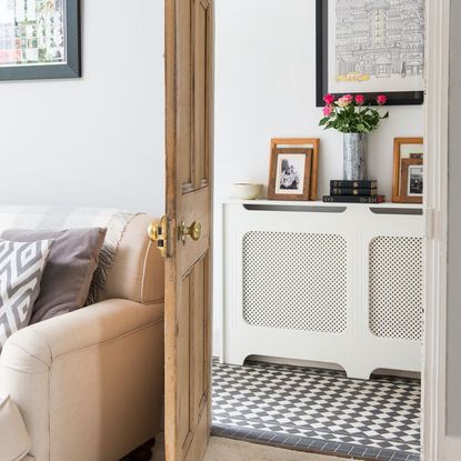 room with white wall and wooden door