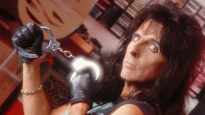 Alice Cooper holding a pair of handcuffs