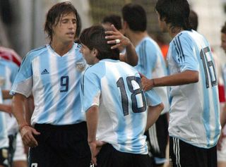 Lionel Messi is consoled by Argentina team-mate Hernan Crespo after being sent off on his international debut against Hungary in August 2005.