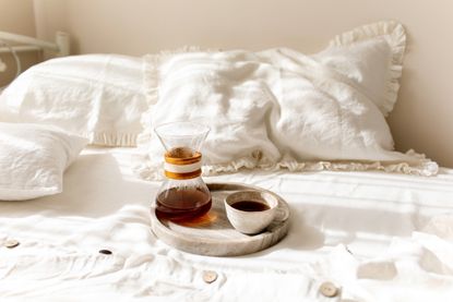 best mattress protector - coffee set up on bed 