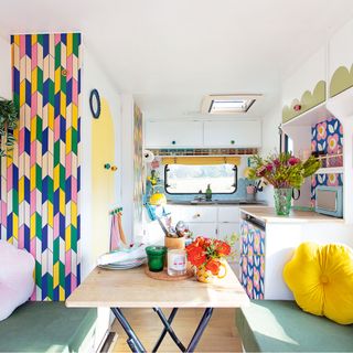 Caravan makeover with bright wallpaper and seating area