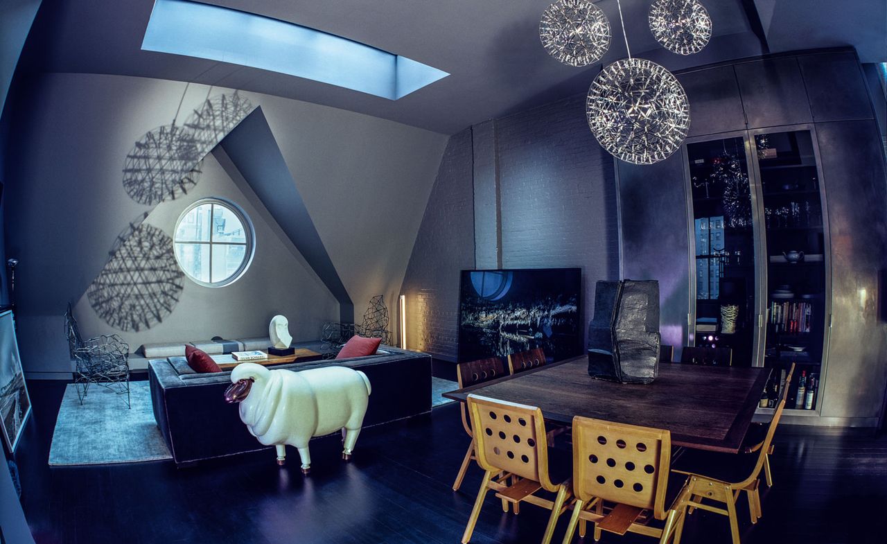 the attic living area, featuring, from left, two ‘Stork Nest’ chairs, $12,000 for pair, by Démiurge; a sheep in cream lacquer, $9,750, by Robert Kuo; Luray Caverns, VA, 2006, by Victoria Sambunaris, from Yancey Richardson Gallery; and a dining table from Espasso with stackable chairs by Roland Rainer