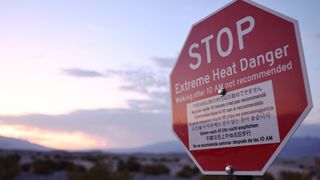 A sign in the desert that reads "STOP: Extreme Heart Danger, walking after 10am not recommended"