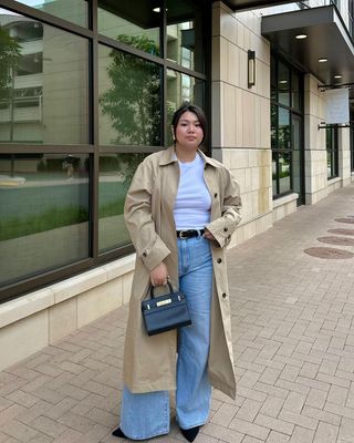 @marina_torres wearing jeans and a t-shirt and trench coat