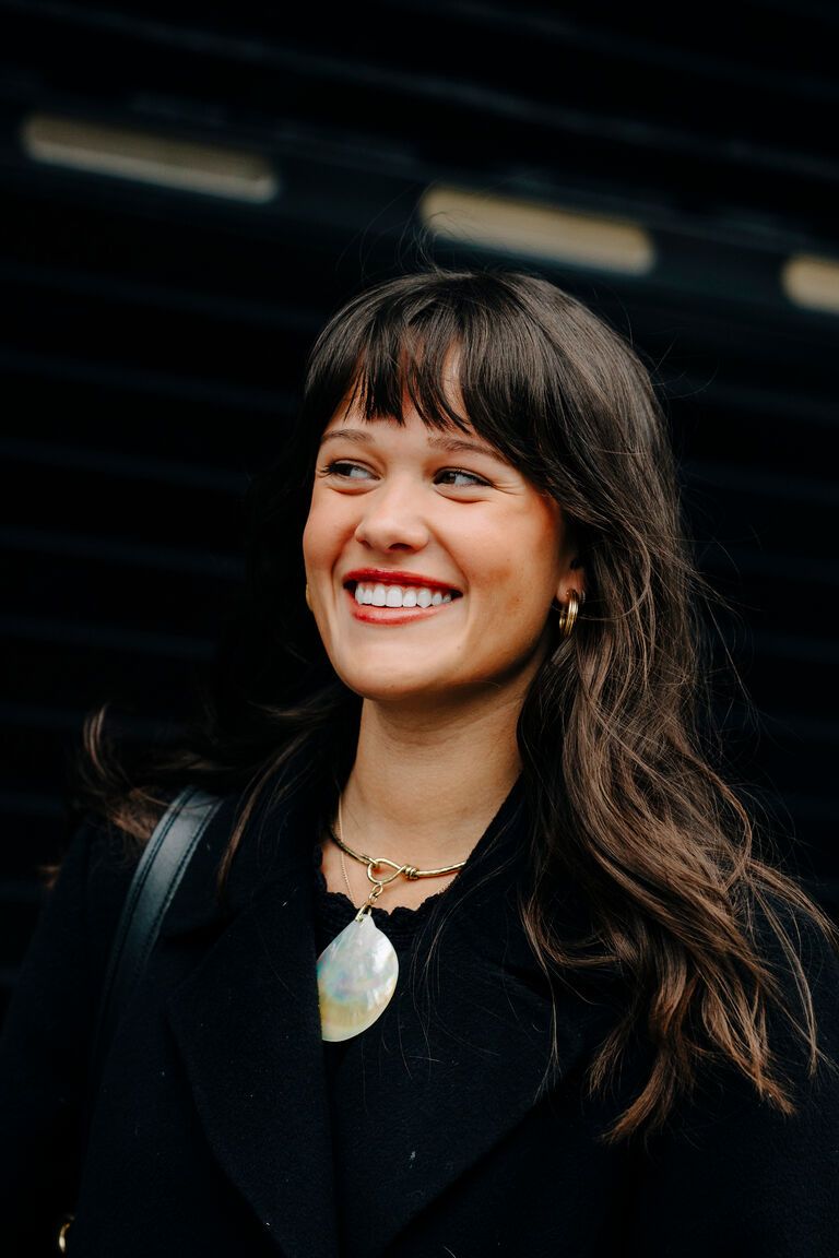 a woman wearing the shell motif jewelry summer 2026 trend at fashion week